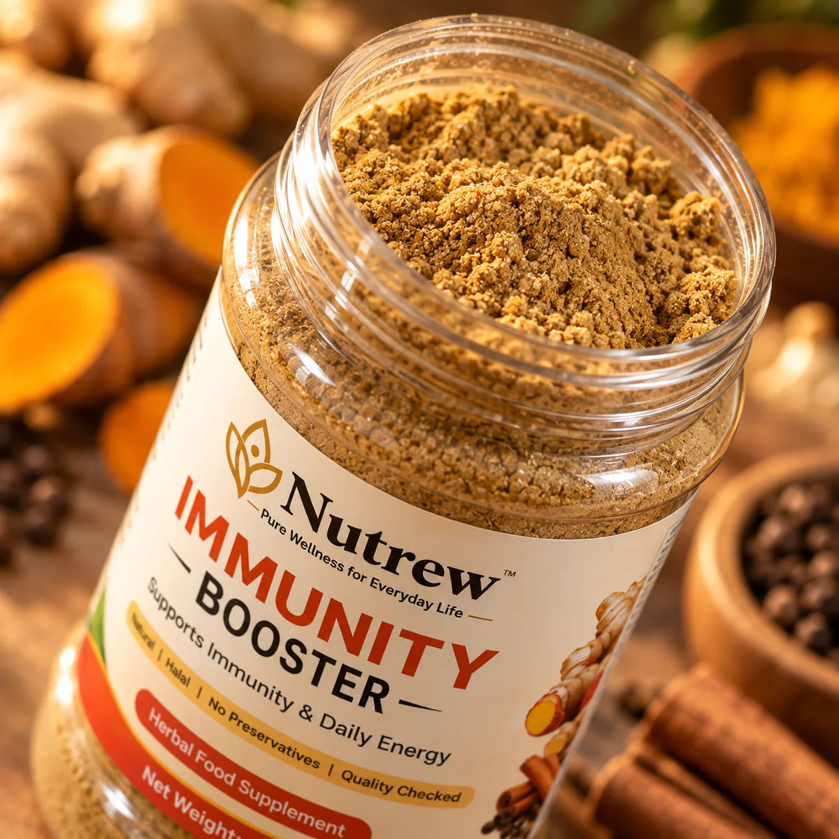 A close-up of a clear jar of Nutrew Immunity Booster powder, showing the brown herbal powder inside, with a white label and warm background elements including turmeric root and cinnamon.