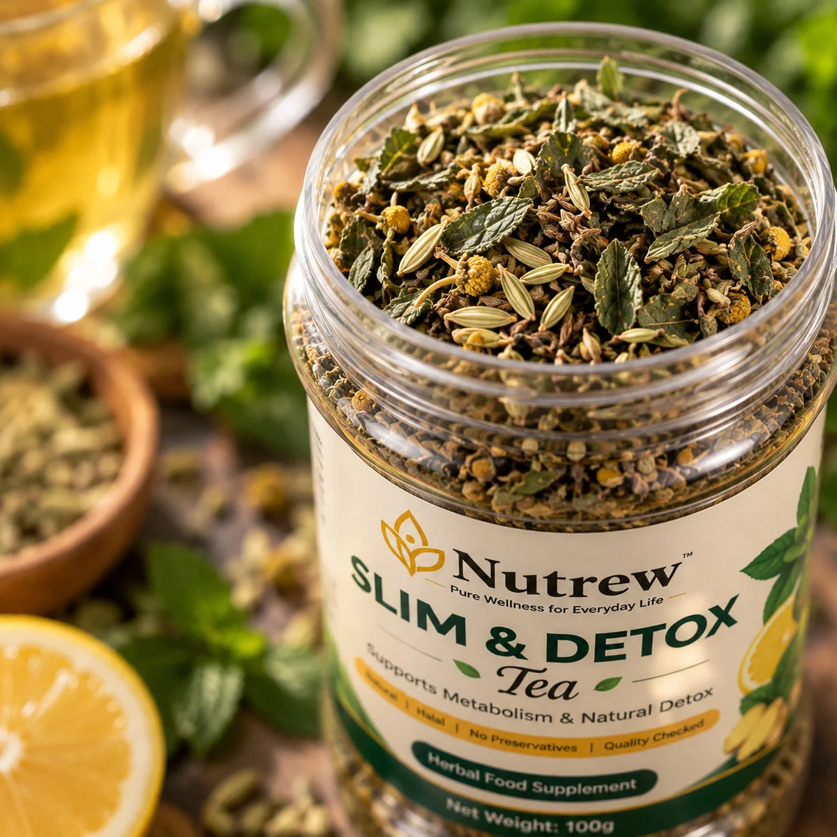 A clear plastic jar of Nutrew Slim & Detox Tea filled with dried herbal ingredients, shown on a styled background with mint leaves, a lemon slice, and a blurred glass of tea.