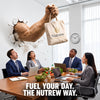 A beige tote bag with the Nutrew logo hangs from a giant muscular arm bursting through a wall in a modern office. Four office workers sit at a conference table looking up in surprise.