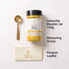 Nutrew Immunity Booster jar with a black lid, shown on a white background with a gold measuring scoop, a cream-colored product leaflet, and text labels reading 'Immunity Booster Jar 150g', 'Measuring Scoop', and 'Product Leaflet'.
