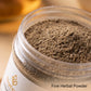 A close-up of a clear plastic jar filled with fine brown herbal powder, with a white label partially visible. The text 'Fine Herbal Powder' appears in the lower right corner.